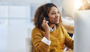 A legal intake specialist is talking on the phone with a potential client. Custom intake services for law firms produce higher conversion rates.